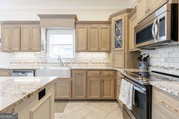 a kitchen with stainless steel appliances granite countertop a sink and stove top oven