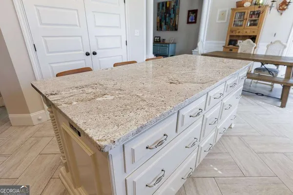 a spacious bathroom with a granite countertop sink and a mirror