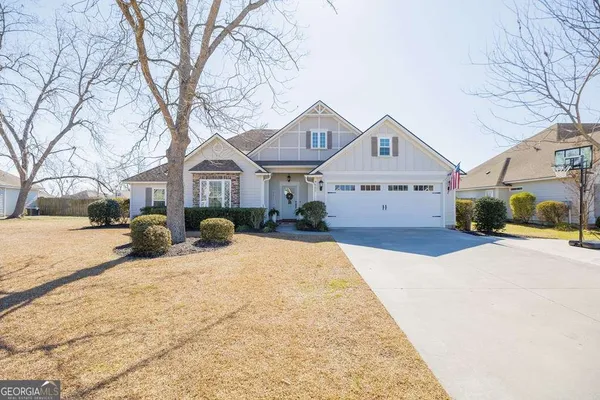 a front view of a house with a yard covered in snow