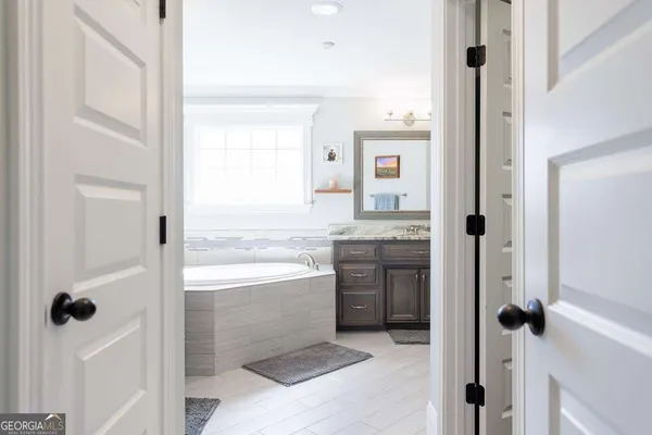 a bathroom with a granite countertop sink a toilet and shower