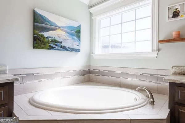 a bathroom with a bathtub and window