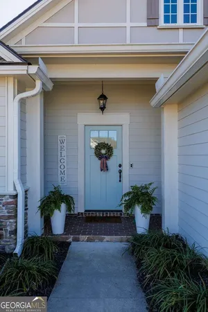 a front view of a house with potted plants