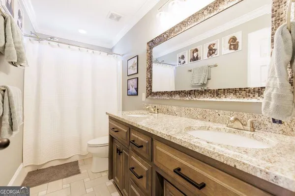 a bathroom with a granite countertop sink and a mirror a