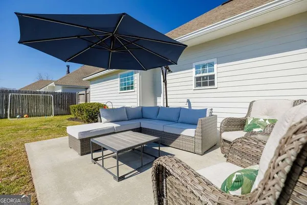 a backyard of a house with table and chairs