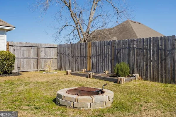 a backyard of a house with table and chairs