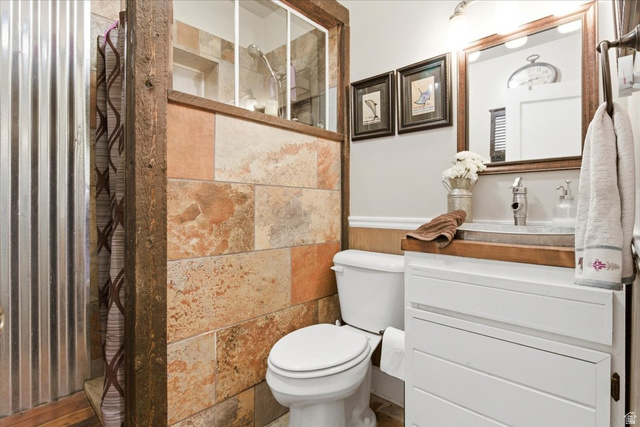 287 South 100 East Spring City, UT 84662 - Photo 23 of 44 Half bath featuring a tile shower, vanity, and wainscoting