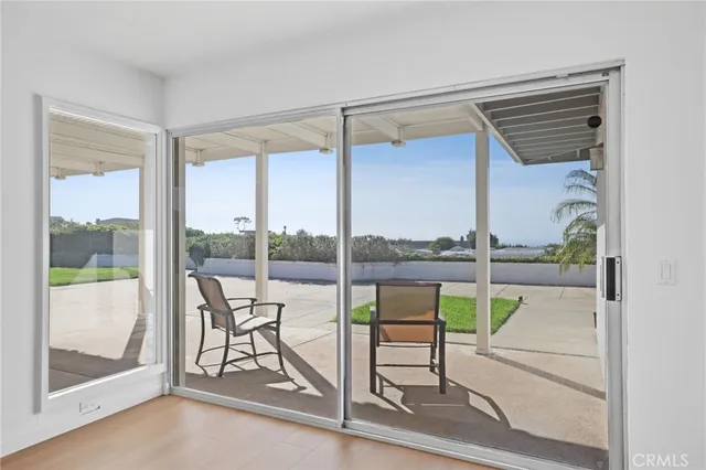 a view of a balcony with table and chairs