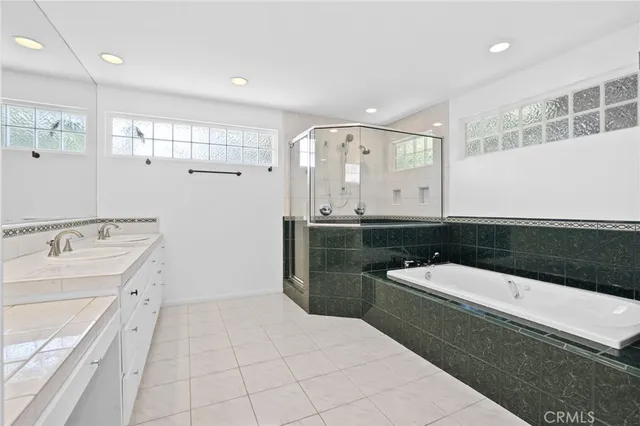 a bathroom with a double vanity sink and mirror