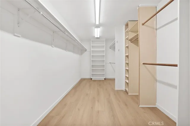 a view of hallway with stairs and wooden floor