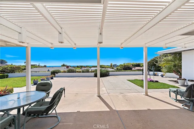 a view of a patio with a table and chairs