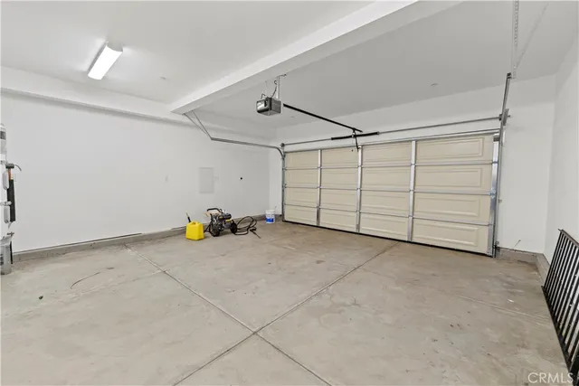 a large white kitchen with sink and dishwasher