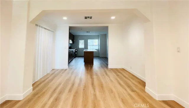 an empty room with wooden floor