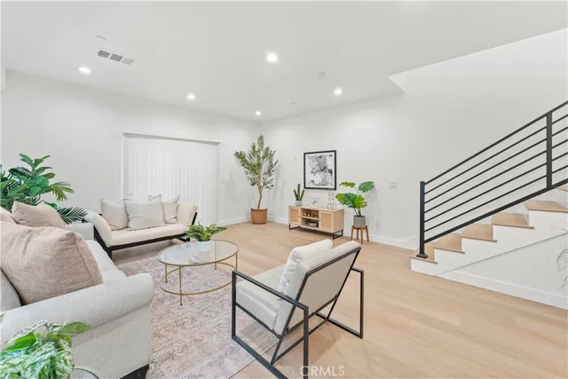 a living room with furniture and a potted plant