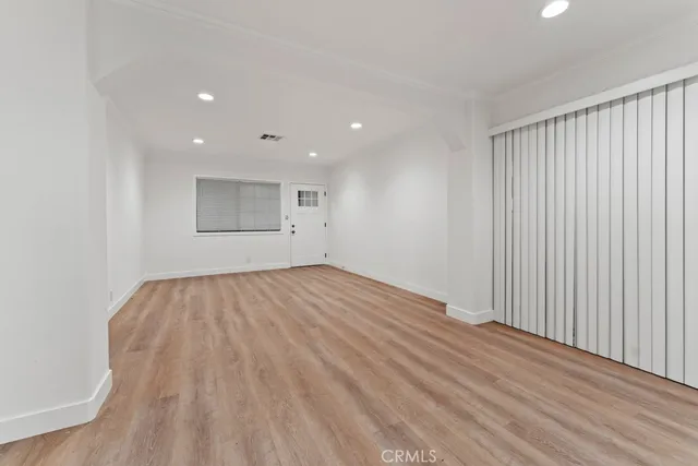 a bedroom with a bed and a potted plant