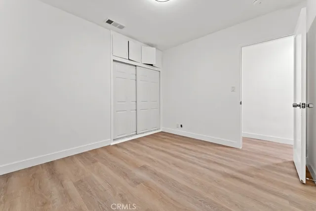 a bedroom with a bed and a painting on the wall