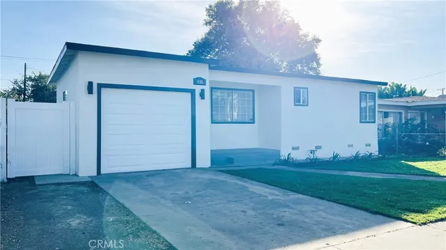 a kitchen with a sink cabinets stainless steel appliances and a window