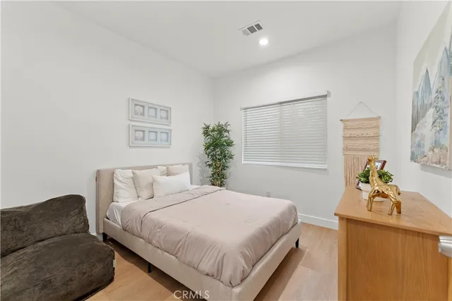 a bedroom with a bed and a couch