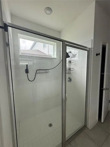 a bathroom with a glass shower door