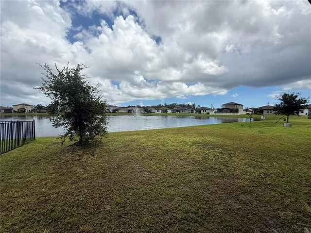 a view of a lake with houses in the back