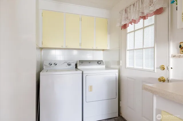 a kitchen with kitchen island a sink appliances cabinets and a counter top space