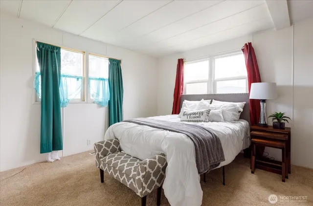 a bedroom with a large bed and a window