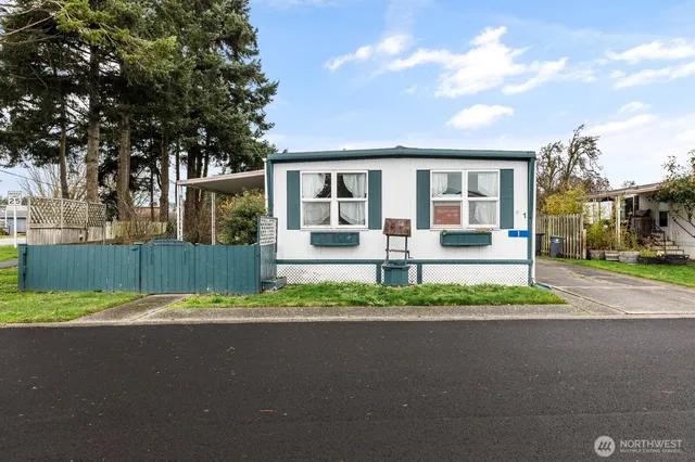 a front view of a house with a garden and plants