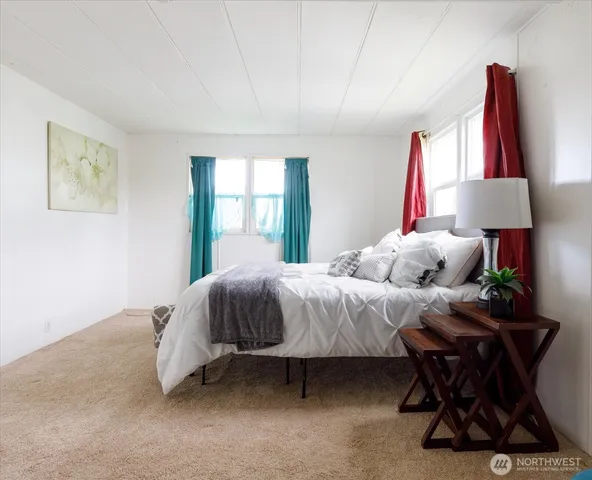 a bathroom with a granite countertop sink mirror vanity and toilet