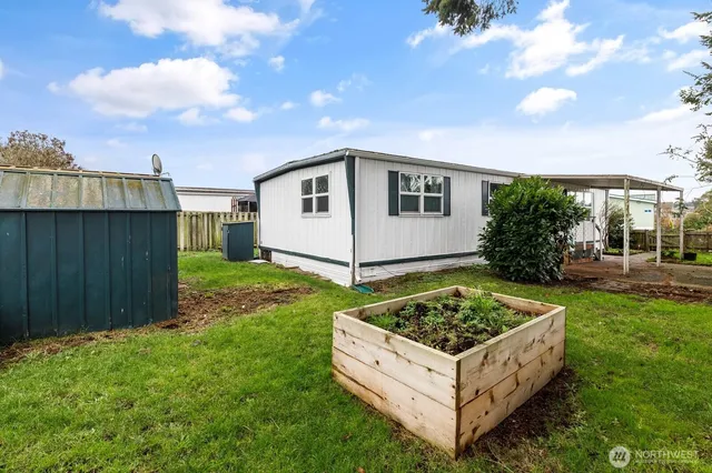 a view of a backyard with plants and a patio