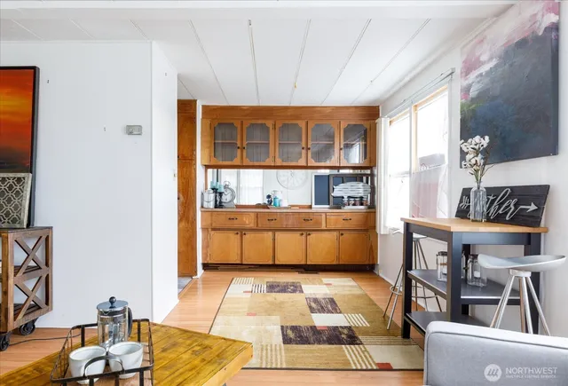 a living room with a couch and a potted plant on a table