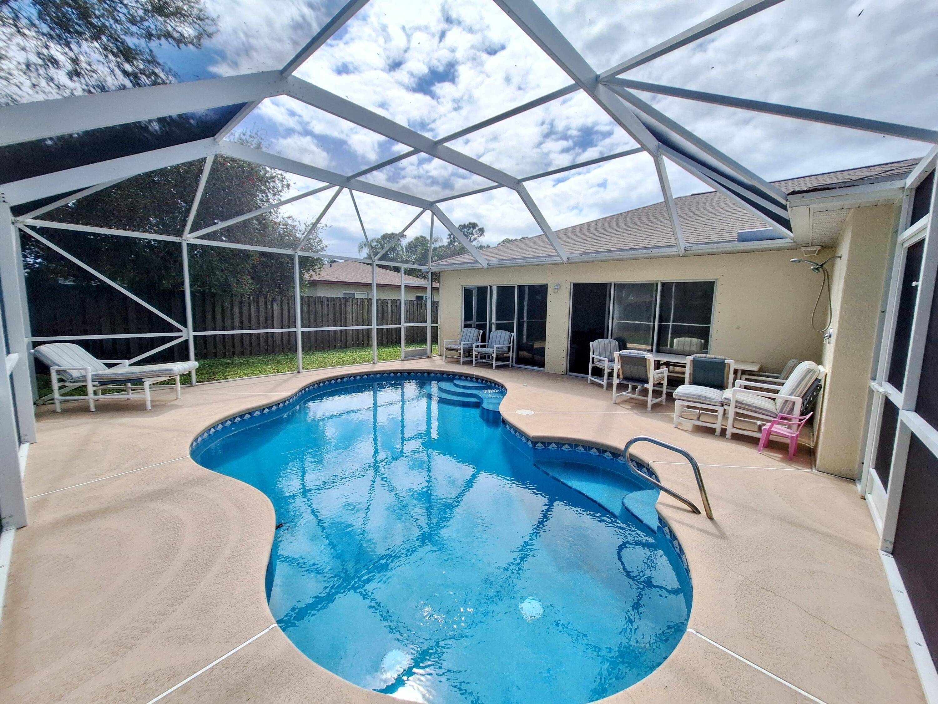 a view of a swimming pool with outdoor seating