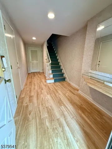 a view of an entryway with wooden floor