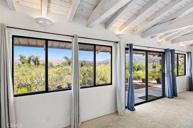 a view of an empty room with windows