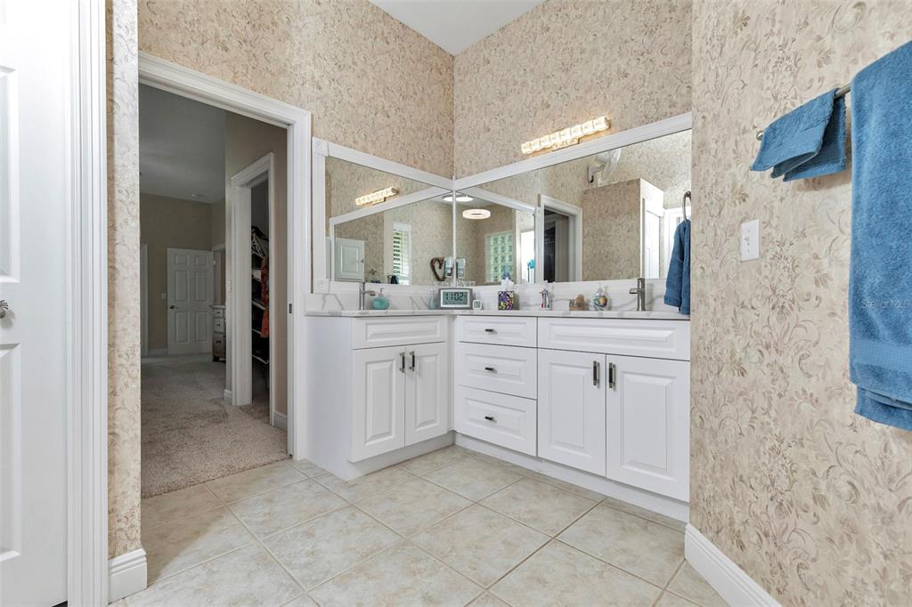 1989 Northwest 111th Loop Ocala, FL 34475 - Photo 27 of 55 a spacious bathroom with a double vanity sink a mirror and a