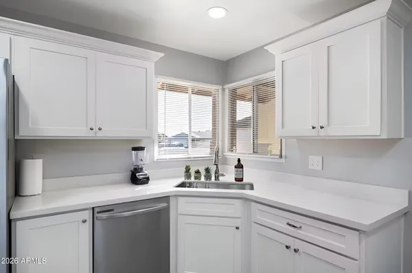 a white bed sitting in a bedroom next to a cabinet