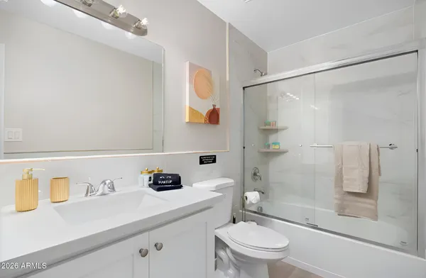 a spacious bedroom with a bed and a flat screen tv