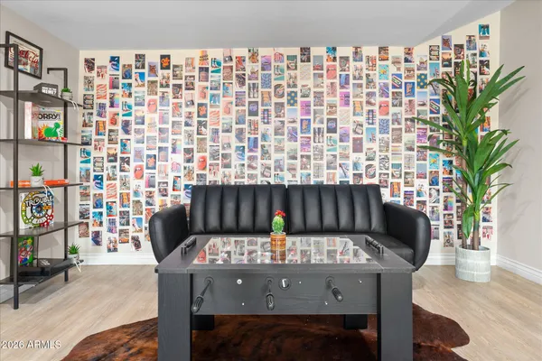 a view of a workspace with furniture and a window