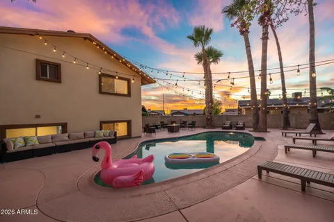 a view of a swimming pool with sitting area