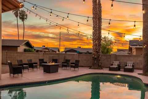a view of swimming pool with outdoor seating