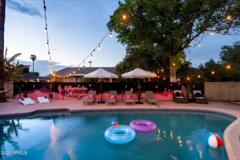 a view of a wooden floor top table and chairs