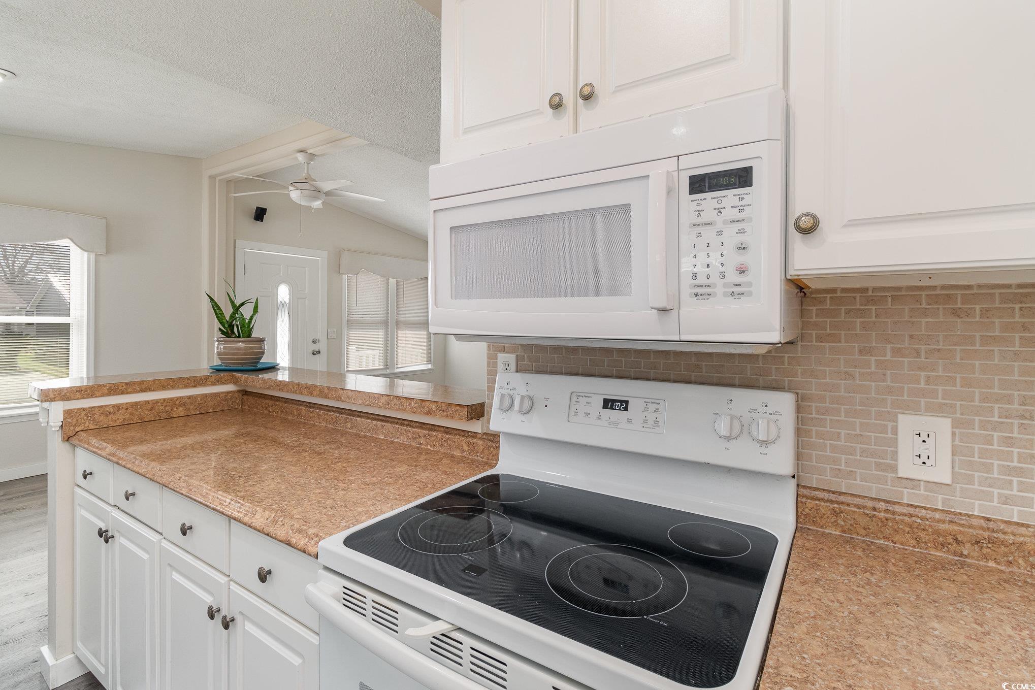 833 Main Sail Court Murrells Inlet, SC 29576 - Photo 29 of 40 Kitchen featuring white cabinetry, white appliance