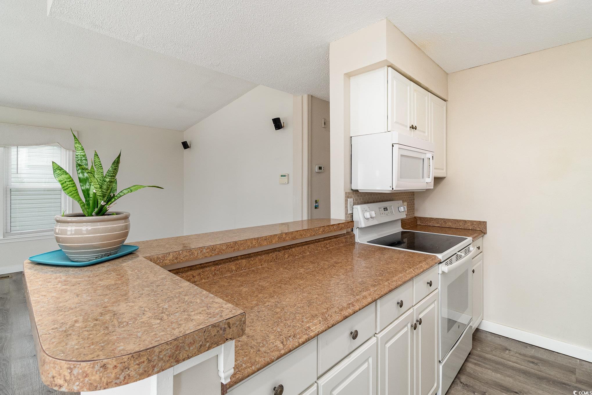 833 Main Sail Court Murrells Inlet, SC 29576 - Photo 31 of 40 Kitchen with white appliances, a textured ceiling,