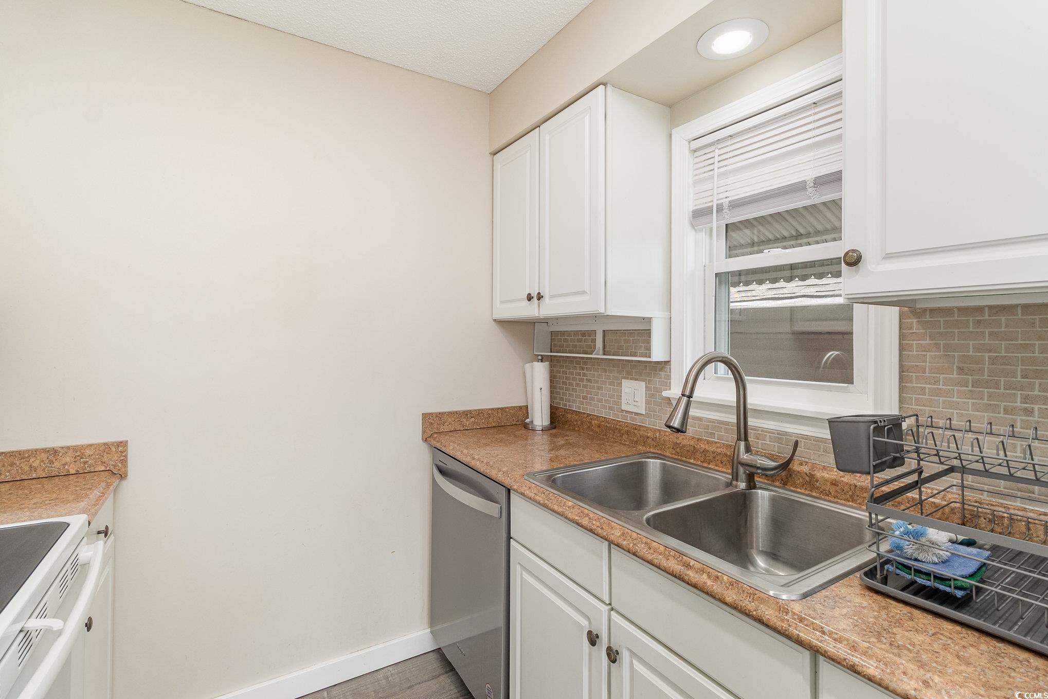 833 Main Sail Court Murrells Inlet, SC 29576 - Photo 4 of 40 Kitchen with a sink, backsplash, white cabinetry,