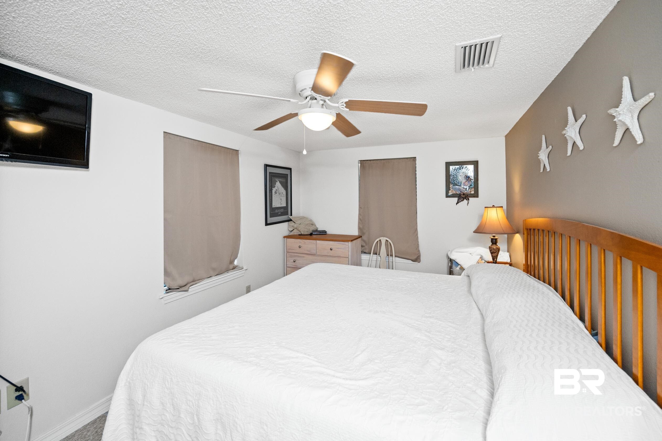 5392 Ornacor Avenue Orange Beach, AL 36561 - Photo 20 of 48 Bedroom with ceiling fan and a textured ceiling