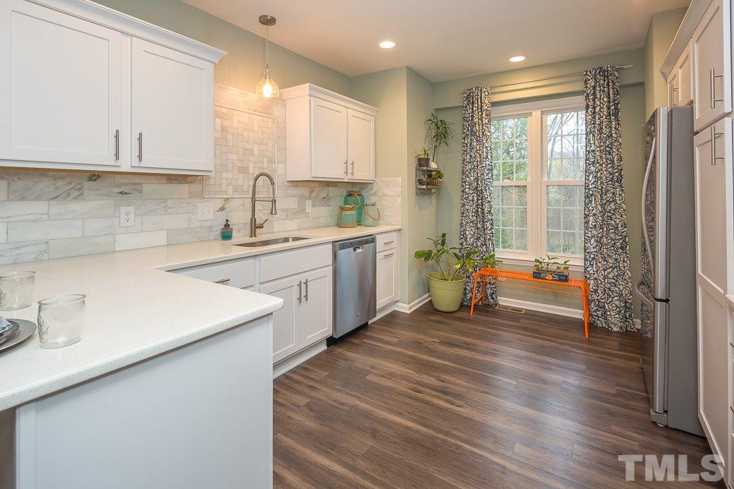 6241 Waterside Lane Raleigh, NC 27613 - Photo 1 of 16 a kitchen with a sink cabinets stainless steel appliances and a window