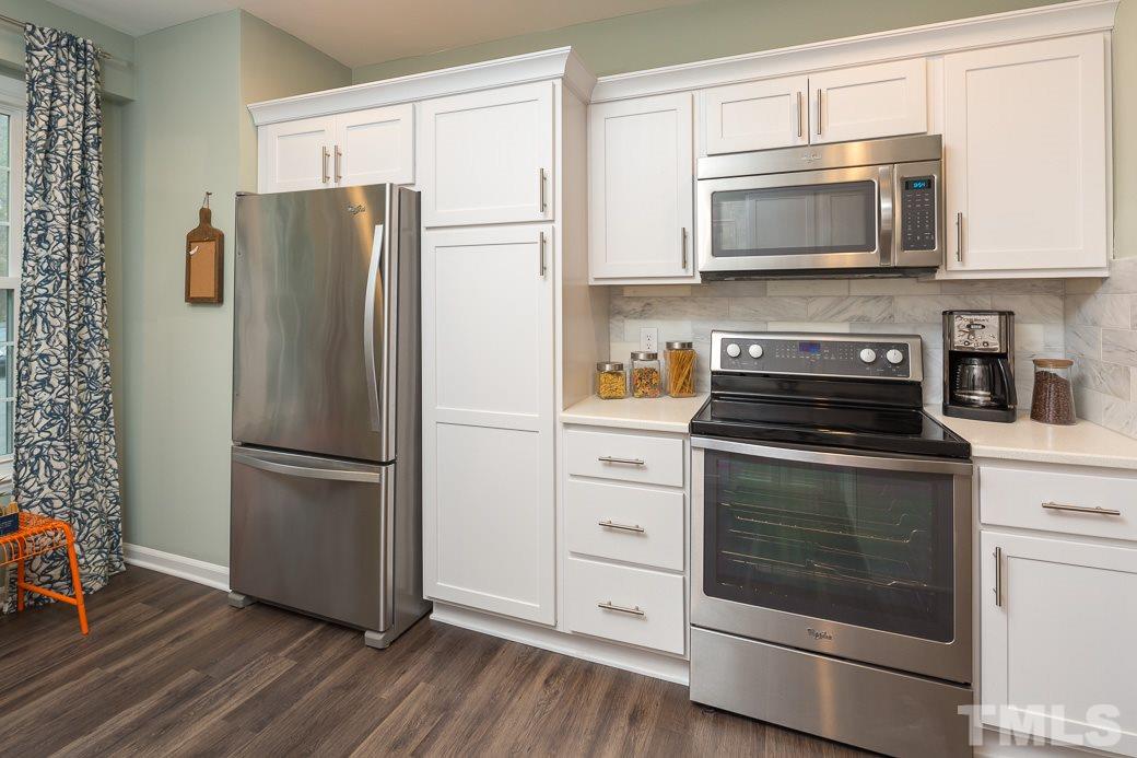 6241 Waterside Lane Raleigh, NC 27613 - Photo 2 of 16 a kitchen with stainless steel appliances a refrigerator stove and microwave