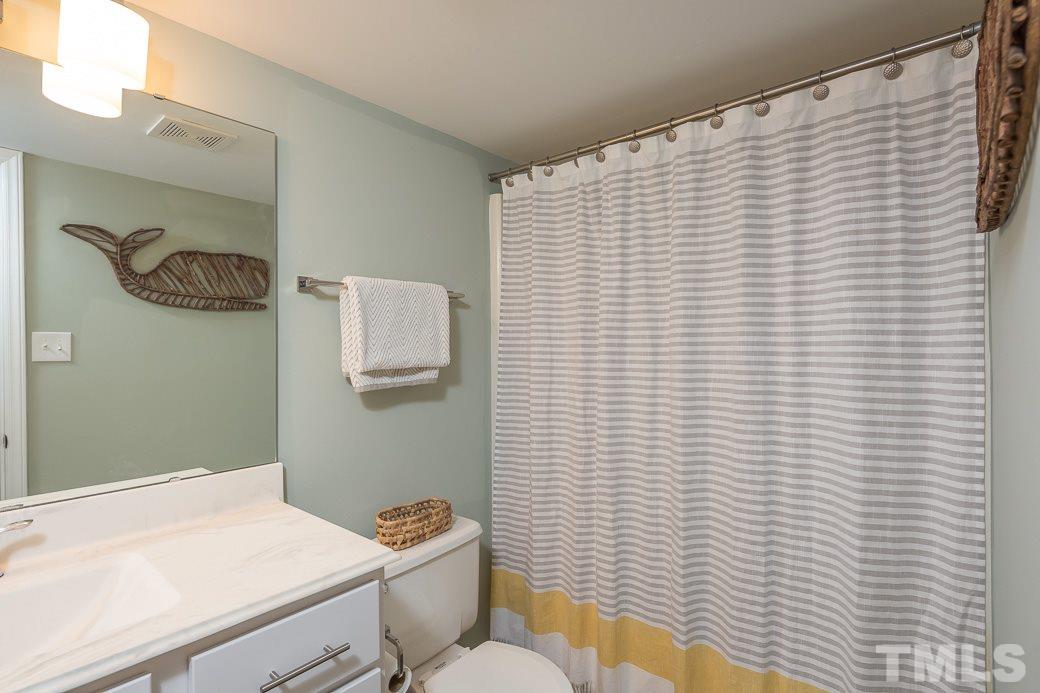 6241 Waterside Lane Raleigh, NC 27613 - Photo 12 of 16 a bathroom with a sink and a toilet