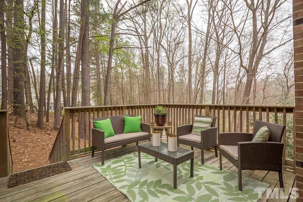 6241 Waterside Lane Raleigh, NC 27613 - Photo 13 of 16 a balcony with wooden floor and outdoor seating