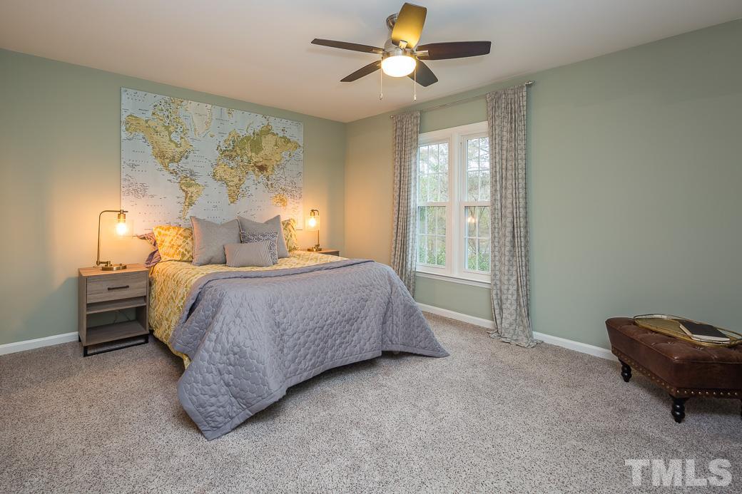 6241 Waterside Lane Raleigh, NC 27613 - Photo 6 of 16 a bedroom with a bed and window