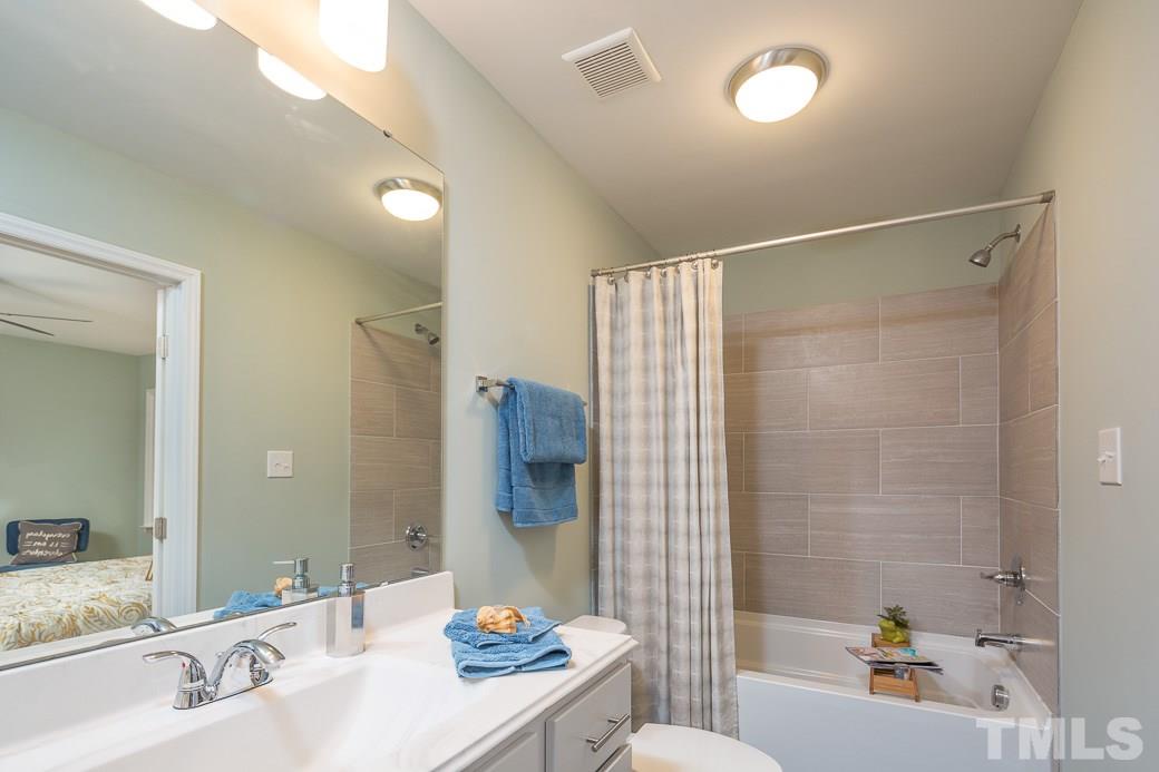 6241 Waterside Lane Raleigh, NC 27613 - Photo 10 of 16 a bathroom with a sink and a mirror