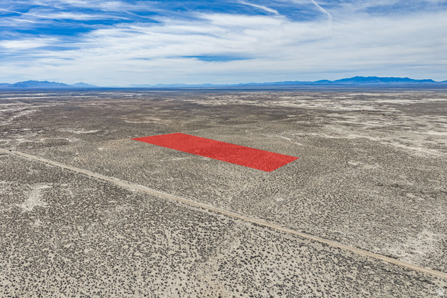 Aerial view of sparsely populated area with mountains and a desert landscape